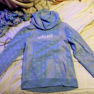 baby blue jacket with paisley patten all around.